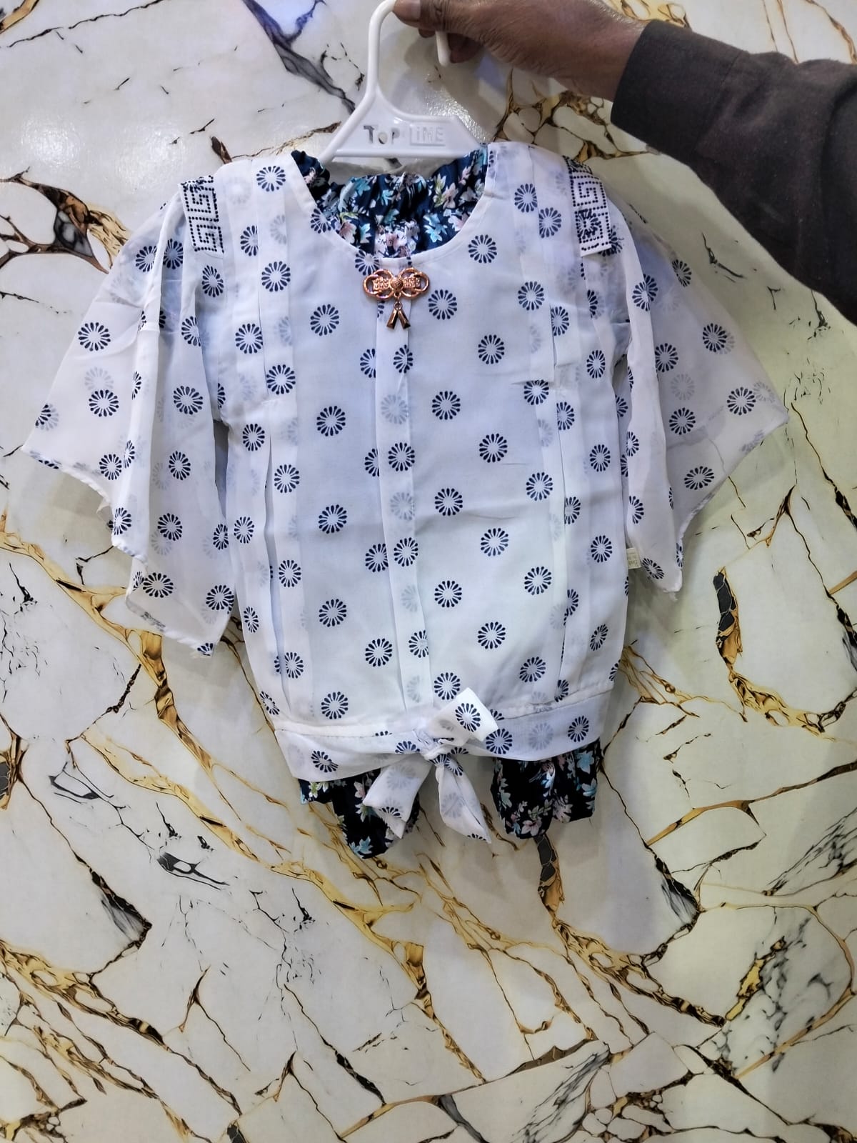 White blouse with blue floral patterns
